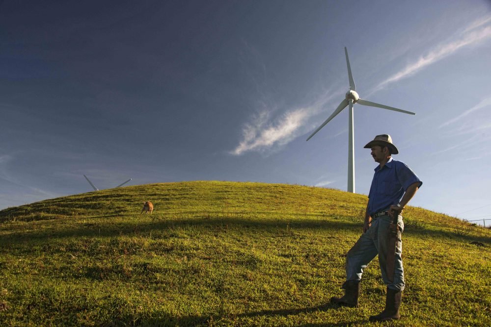 A farmer stands near a wind mill of the National Power and Light Company in Santa Ana, Costa Rica, on Oct. 23, 2015.